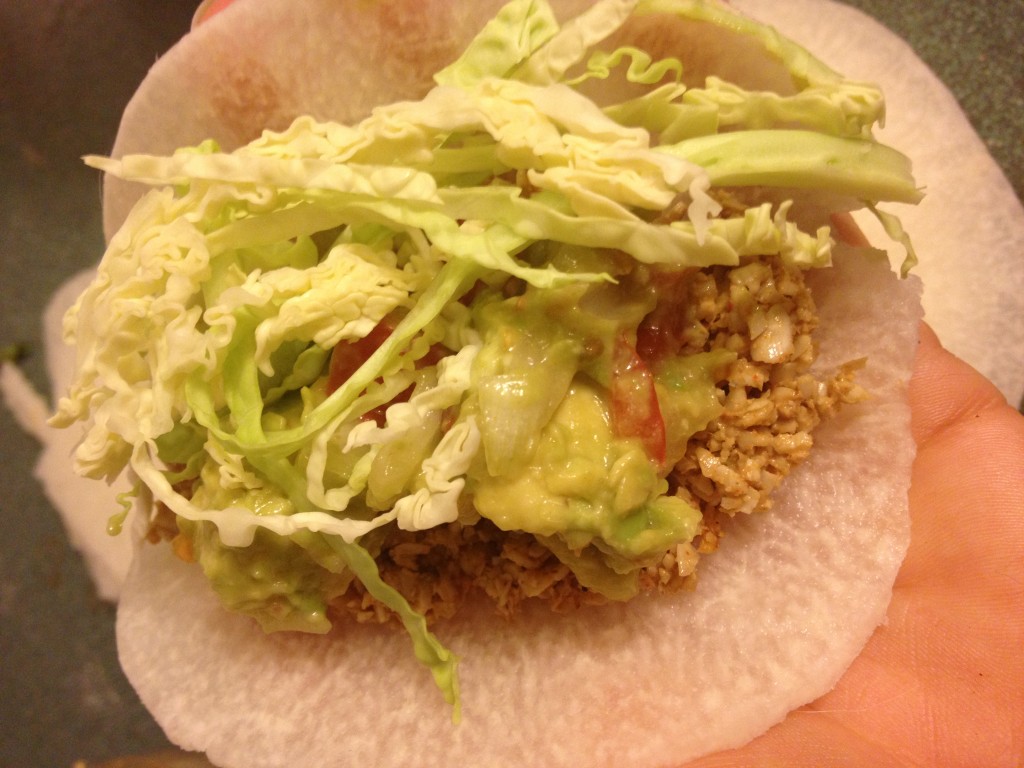 jicama taco with sunflower filling guac and cabbage